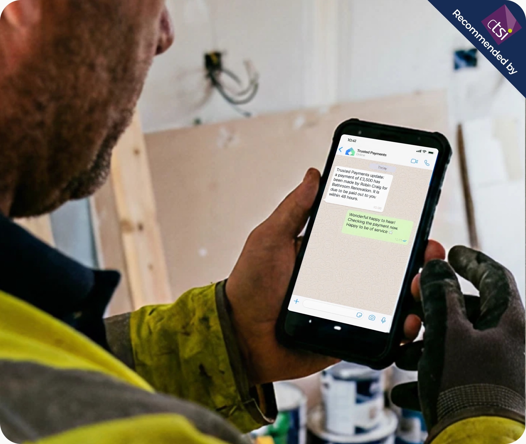 Tradesperson reviewing a project update on the Trusted Payments app